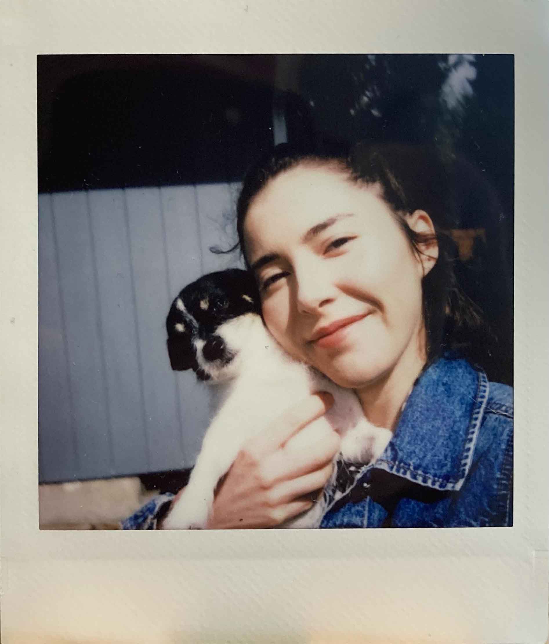 A polaroid photo of Mireille with her dog Dora